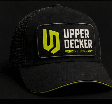 Black Upper Decker trucker hat with the embroidered UD monogram patch